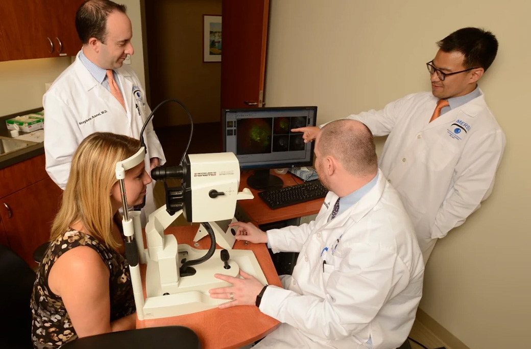 Retina specialists reviewing retinal imaging with a patient at MERSI