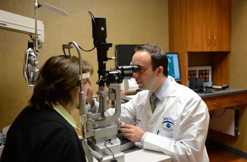 Ophthalmologist performing a slit-lamp eye examination to evaluate uveitis