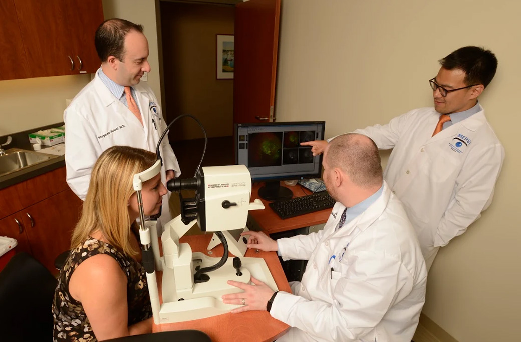 Retina specialist explaining the cause of sudden blurry vision using advanced retinal imaging.