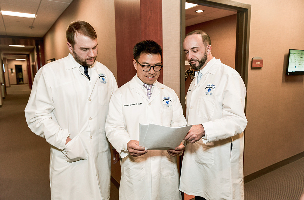 Retina specialist reviewing diagnostic imaging to evaluate a patient's vision