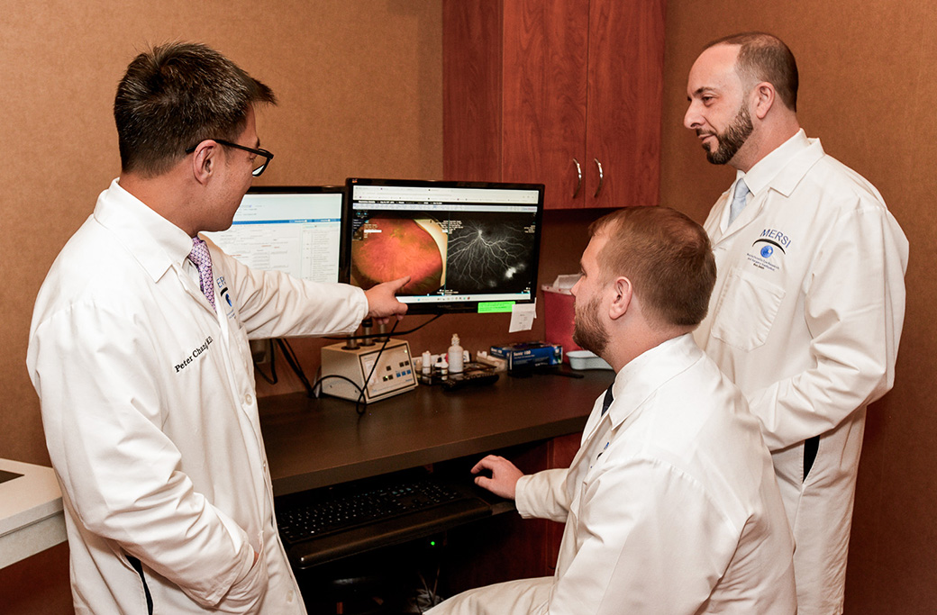 MERSI retina specialist reviewing retinal OCT images during a dry AMD evaluation.