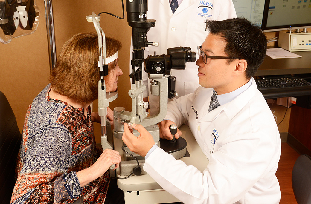 Ophthalmologist examining an older patient’s eyes.