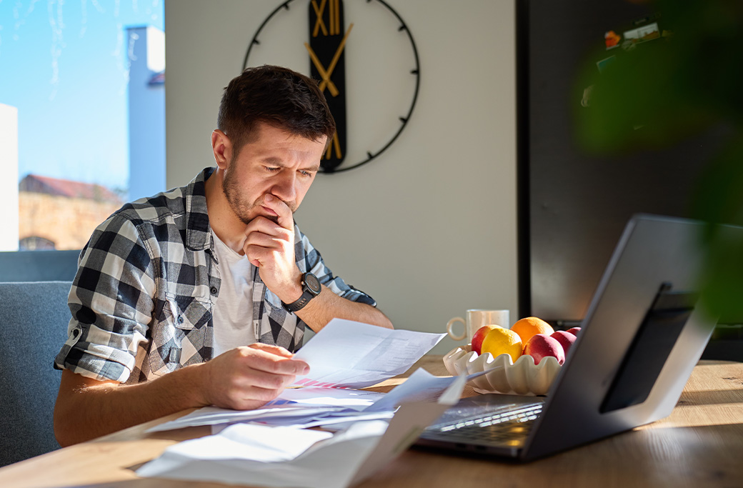 Patient organizing medical records and eye test results before a second-opinion appointment.