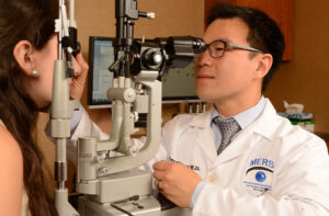 Fellowship-trained MERSI uveitis specialist performing a comprehensive eye examination on a patient