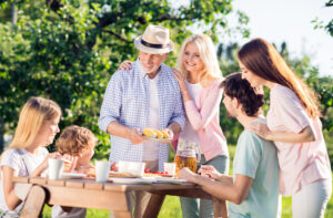 Child, parent and older adult together outdoors representing retinal health at every age.