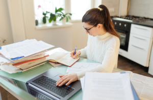 Patient organizing eye-care records and medication information before a specialist consultation.